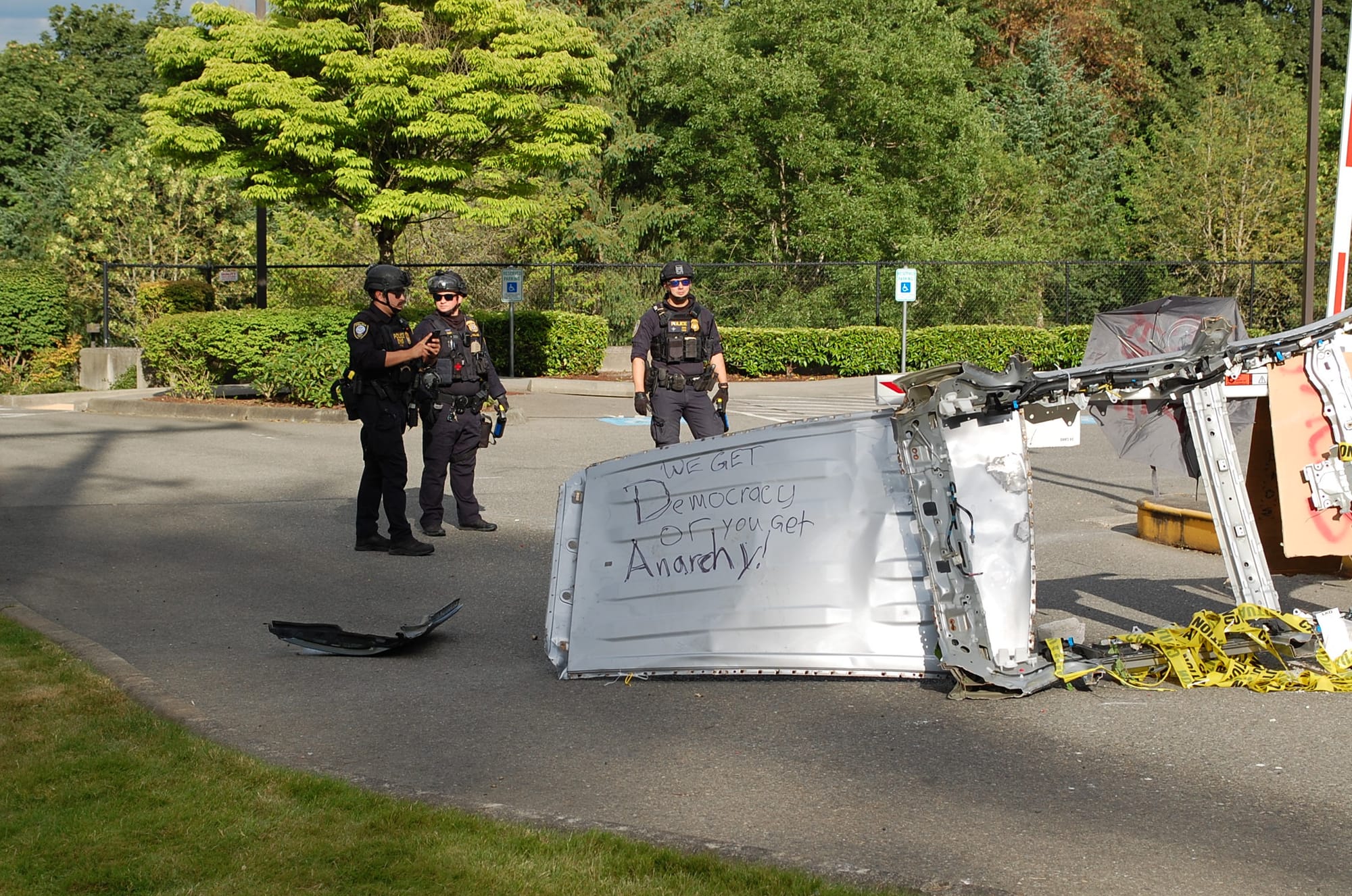 A barricade placed by protesters at an ICE facility in Tukwila south of Seattle. Graffiti reads: We get Democracy or you get Anarchy!