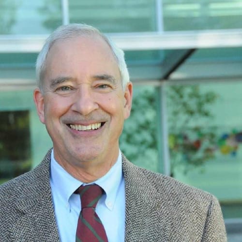 Hugh Spitzer in a tweed jacket and maroon tie.