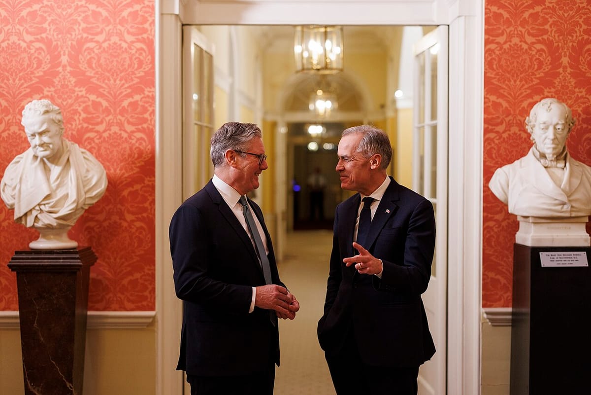 British prime minister Keir Starmer and Candian prime minister Mark Carney share a lighthearted moment inside 10 Downing Street next to a bust of Winston Churchill.