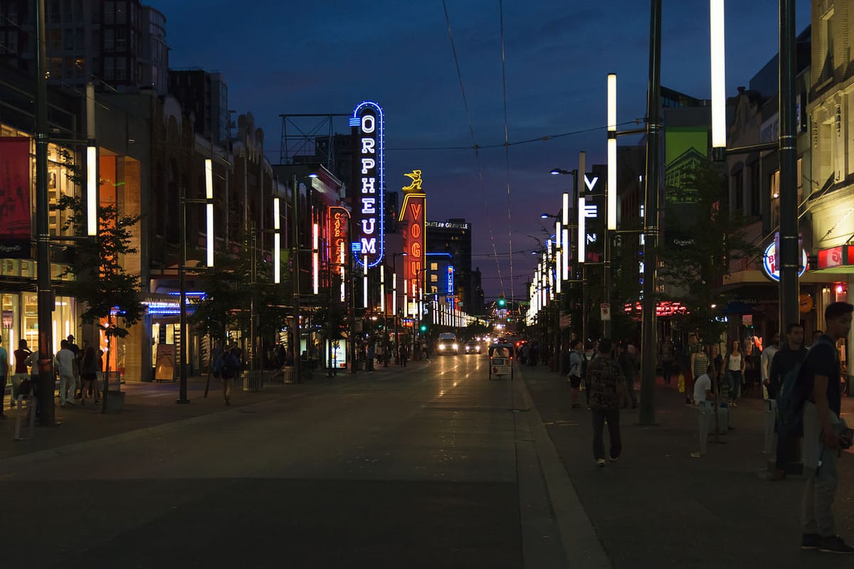 A view at night of Granville street in Vancouver with neon signs from the Orpheum theater and other businesses prominent