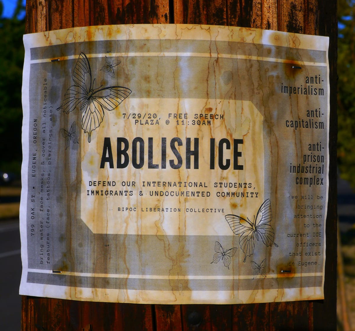A poster on a utility pole advertises a protest calling for the abolition of ICE.