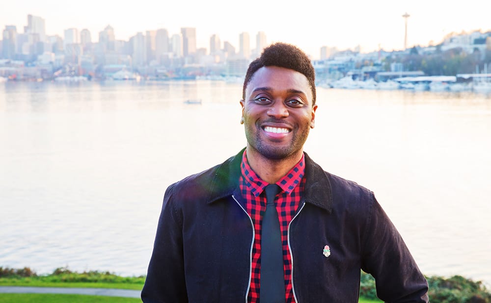 Rep Shaun Scott stands in front of Lake Union with the Seattle syline in the background