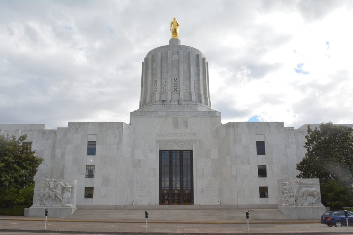 The Oregon state capitol building with clouds in the background