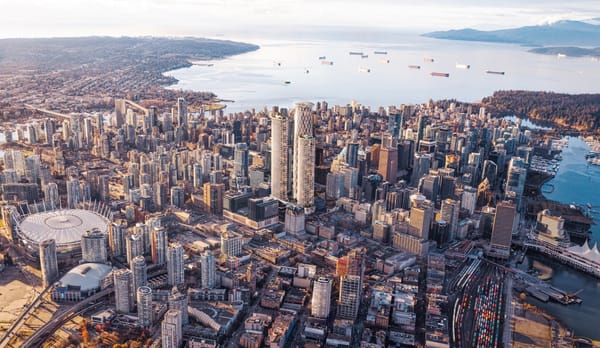 A schematic view of downtown Vancouver with three proposed towers, one over a thousand feet tall, at the center.