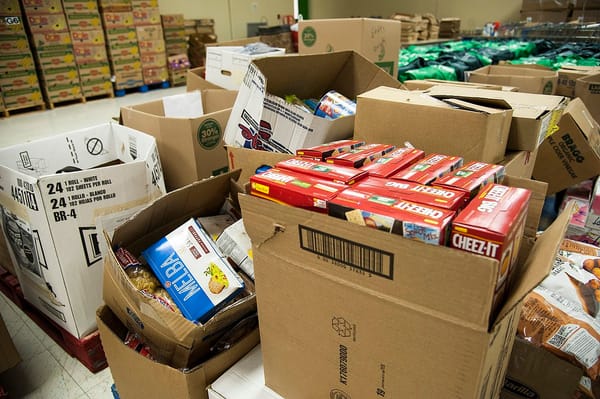 Boxes of food during a food drive, including boxes of crackers and cans of food.
