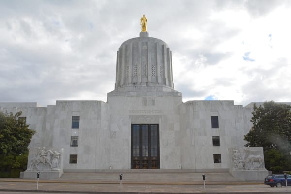The Oregon state capitol building with clouds in the background